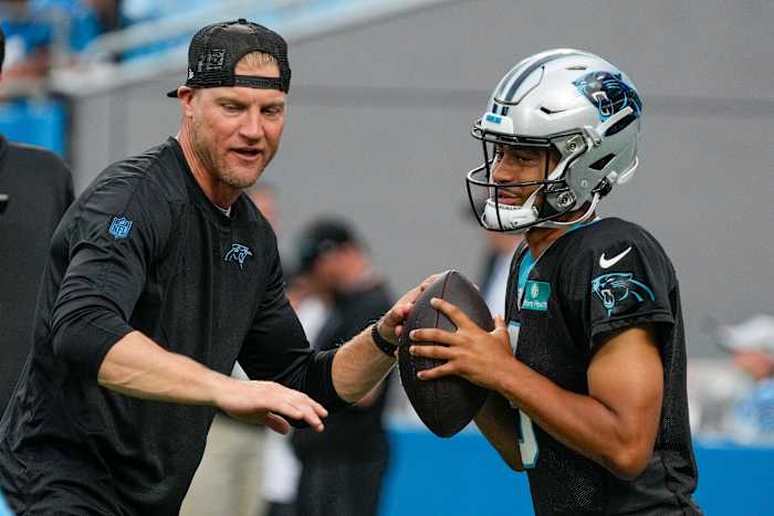 Quarterbacks Coach Josh McCown talks to quarterback Bryce Young while putting his hands out